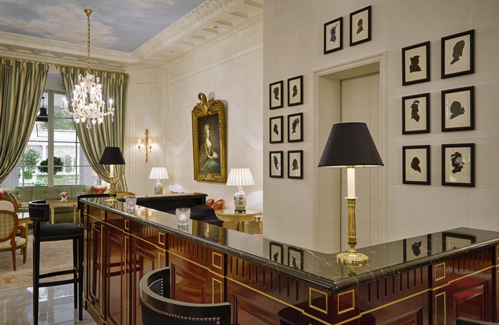 Le Bristol Cafe bar with detailed wood and marquetry work and black leather stools with curved back