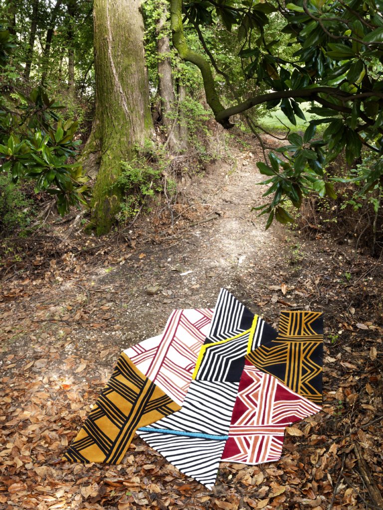 Siamo Tutti Uno several rugs joined together on forest path