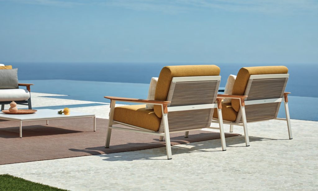 Point City collection rear view of two armchairs with rust-colored upholstery on ocean