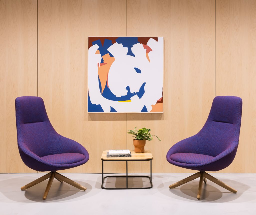 Cove high-back purple two chair in front of painting