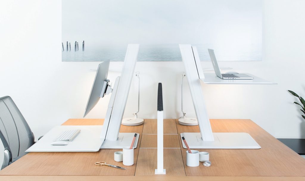 QuickStand Eco view of two with one desktop and one laptop on wooden work surface