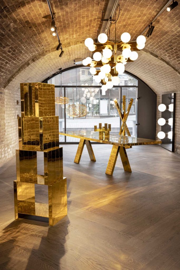 Brass Tom Dixon Mass collection table, coat rack, and bookcase