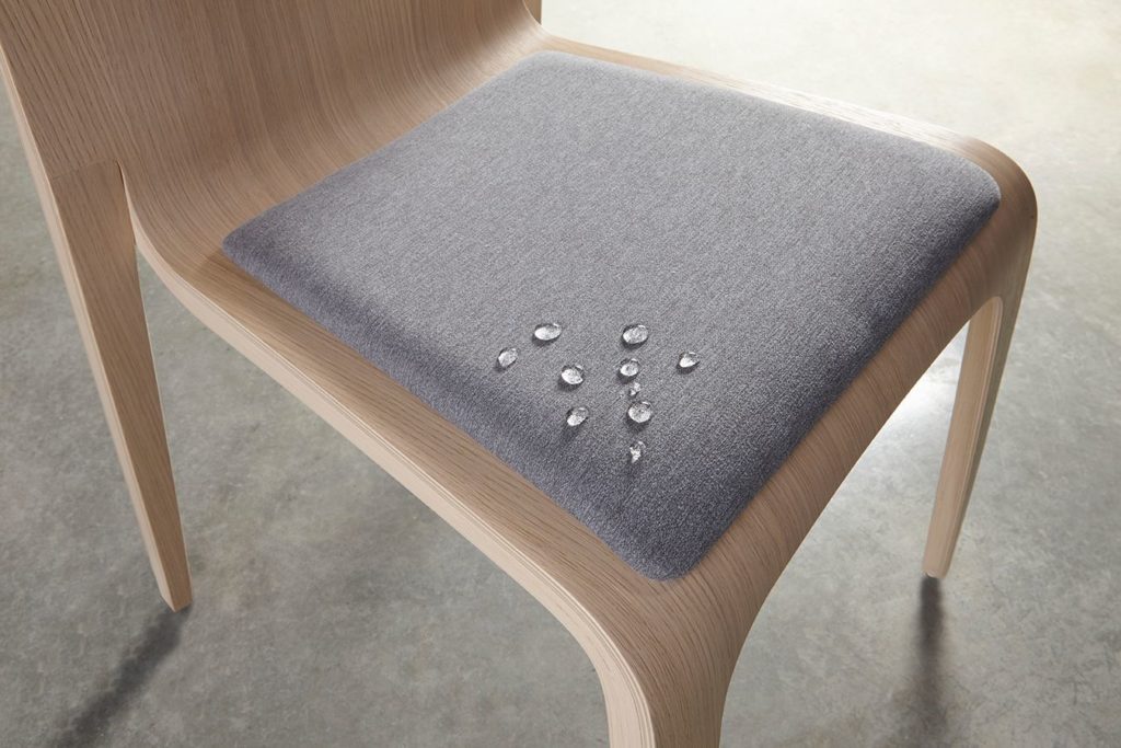 Supreen on dining chair with gray upholstered seat repelling water