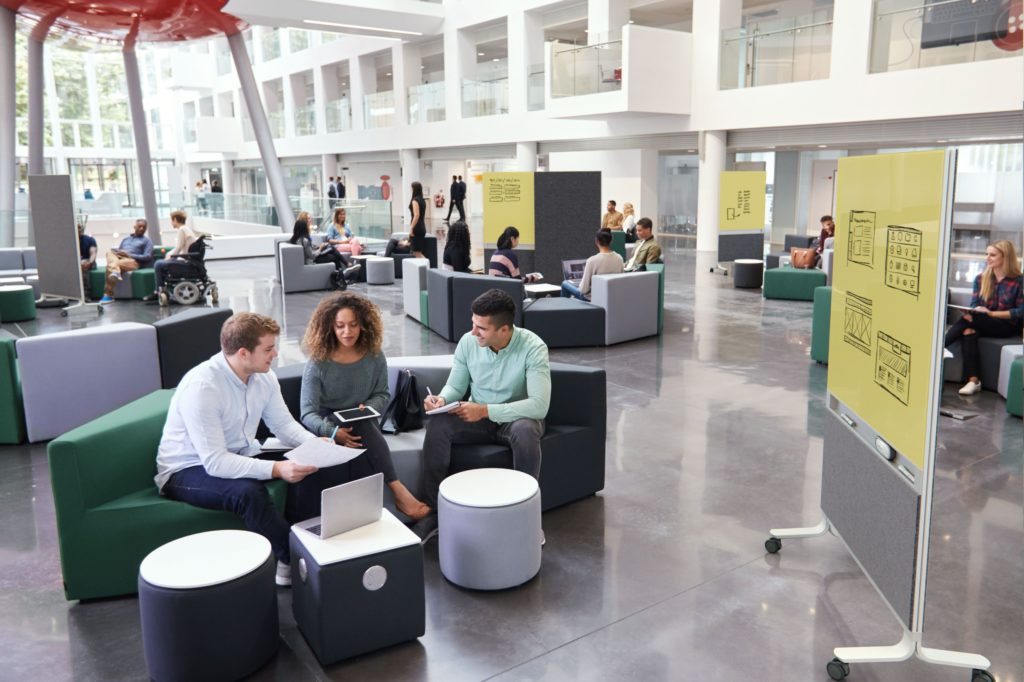 Arden Studio Mobi with yellow/gray in open area with lounge seating and many people