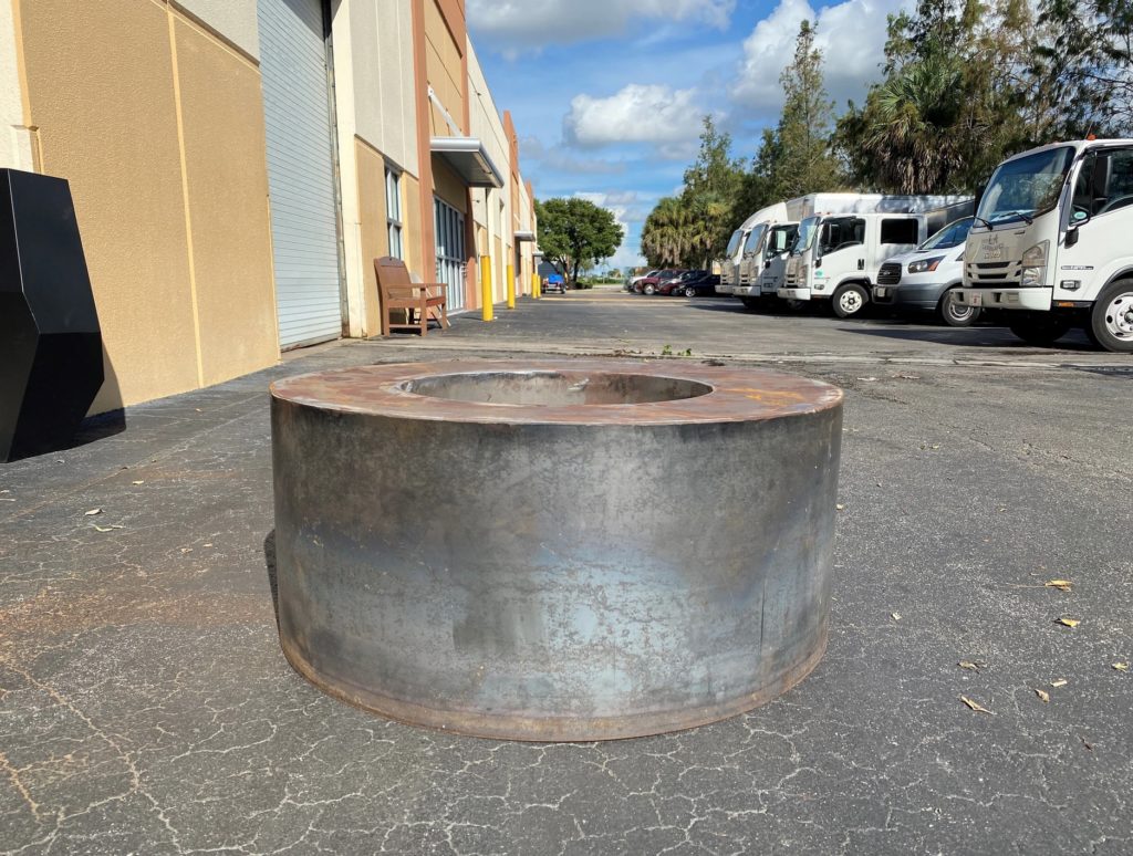 MK Designs fire pit in raw state in alley
