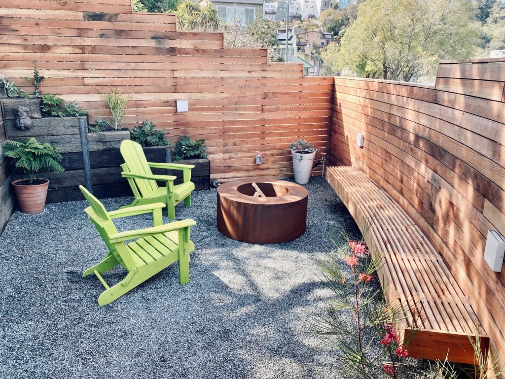 MK Designs Corten fire pit in gravel patio with chairs