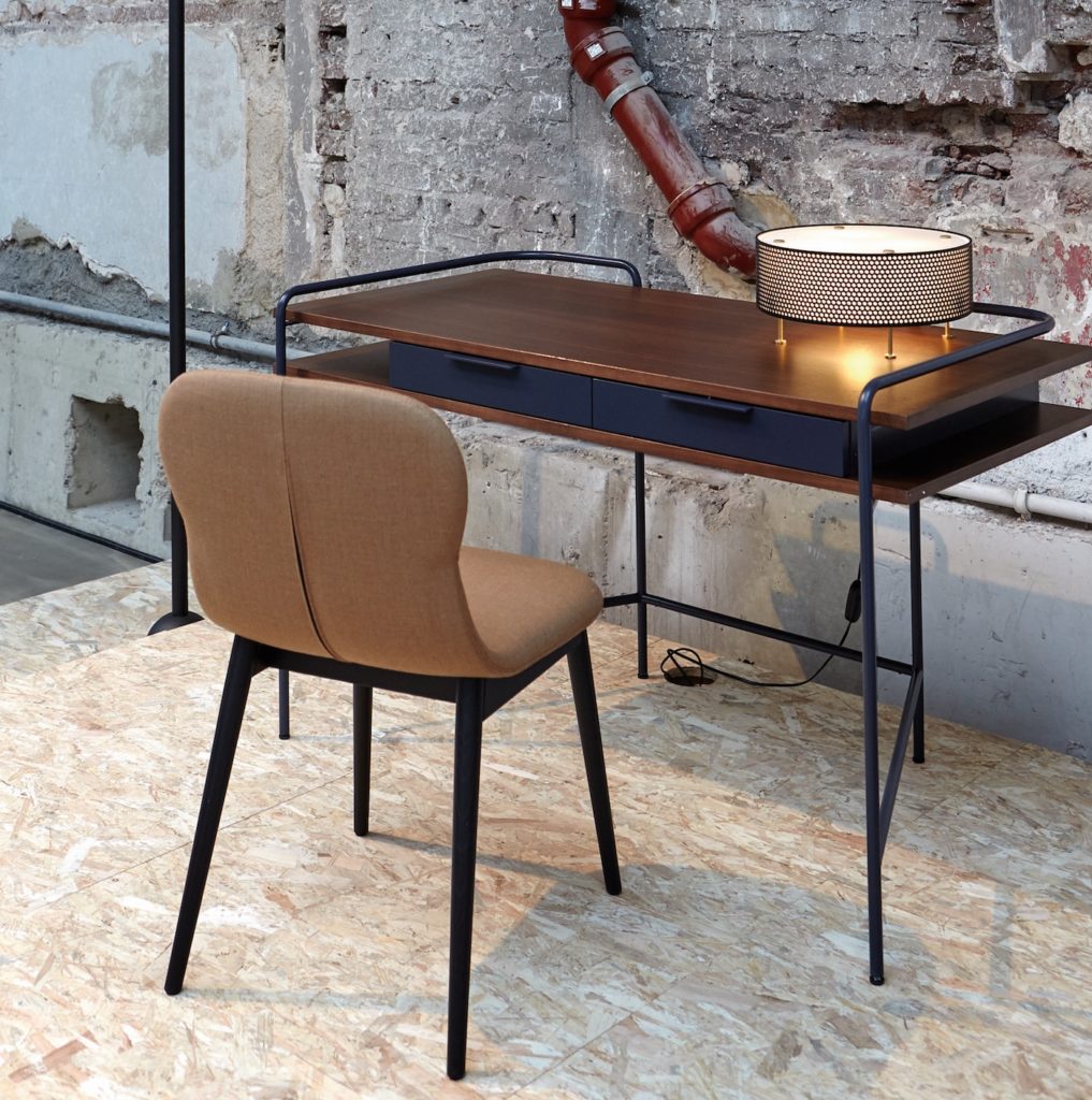 Alando desk in spare room with brown upholstered chair