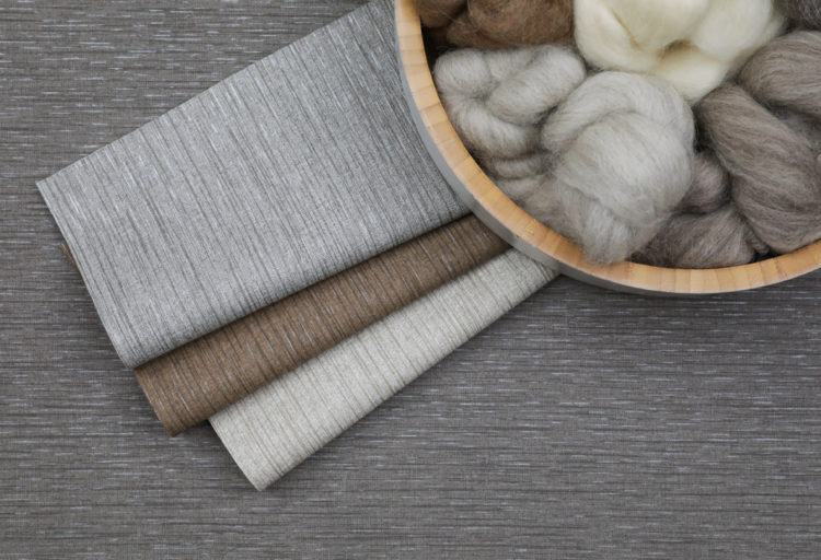 Baxter and Suri dark gray with other color swatches and bowl of yarn