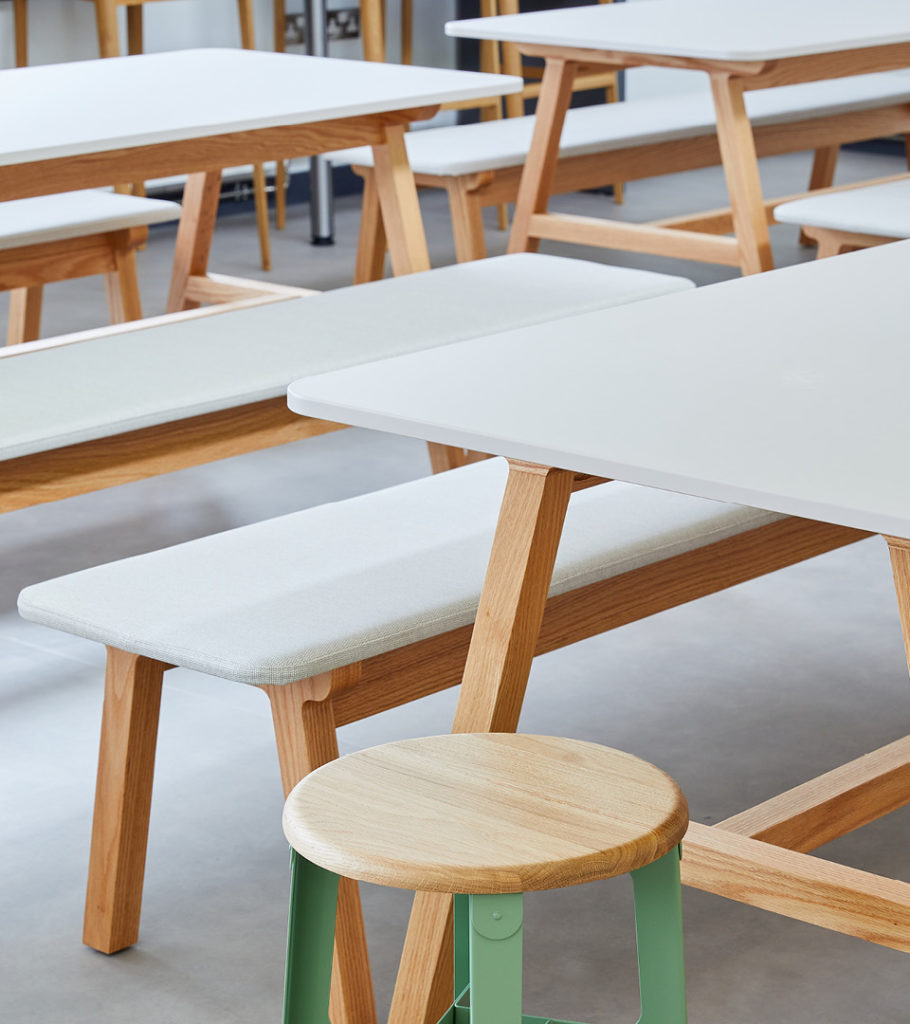 Agent detail of several tables with white tops and wood frames