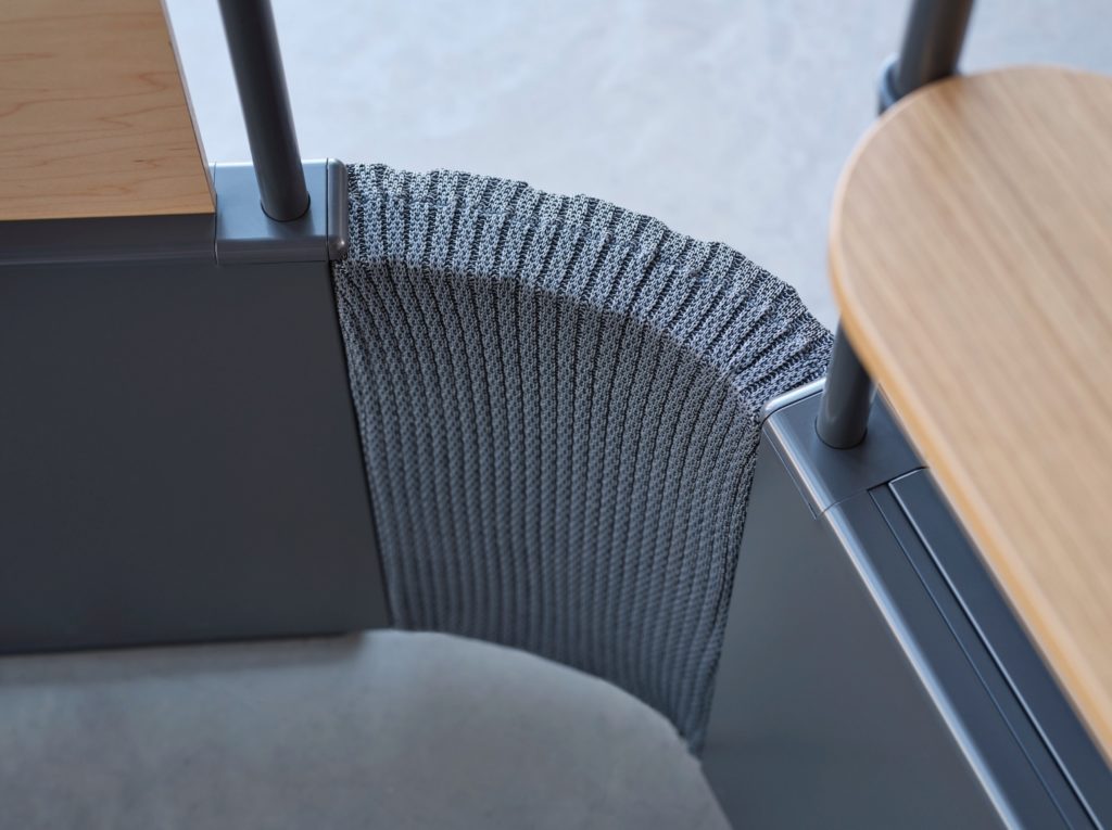 Mural connector detail showing two workstations connected in a curving organic shape