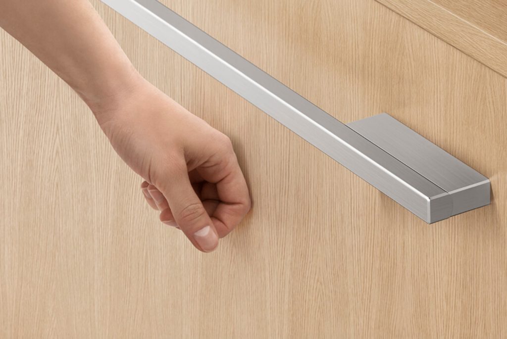 detail of knock-to-pause feature with DishDrawer front in natural wood