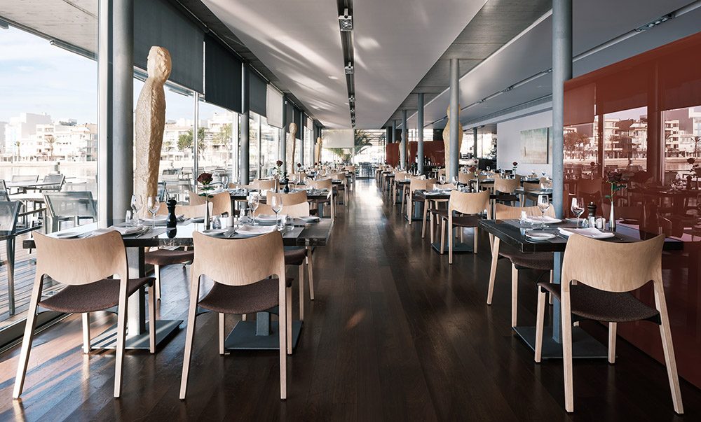 two rows of chairs in natural ash with brown upholstery in restaurant