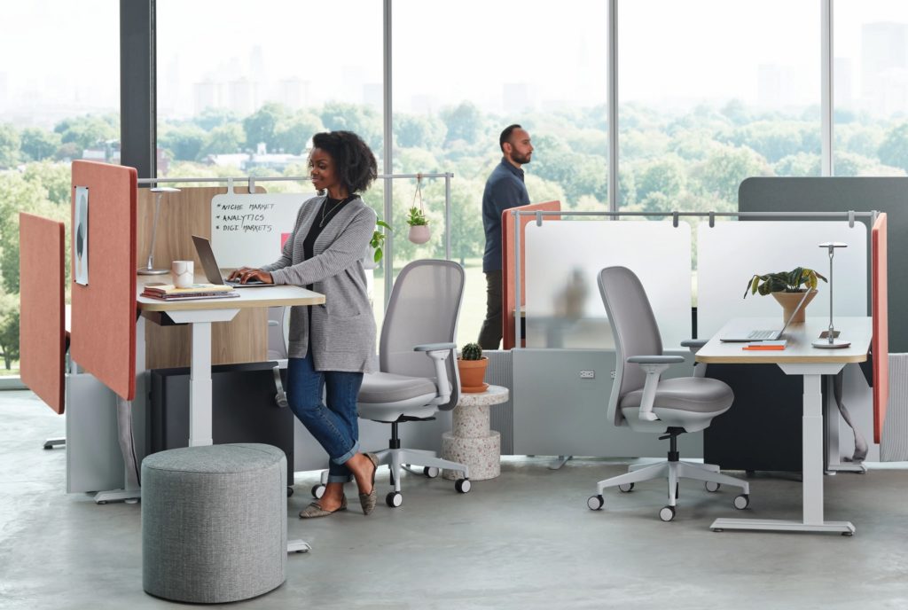 Mural workstation with woman standing and man walking in background