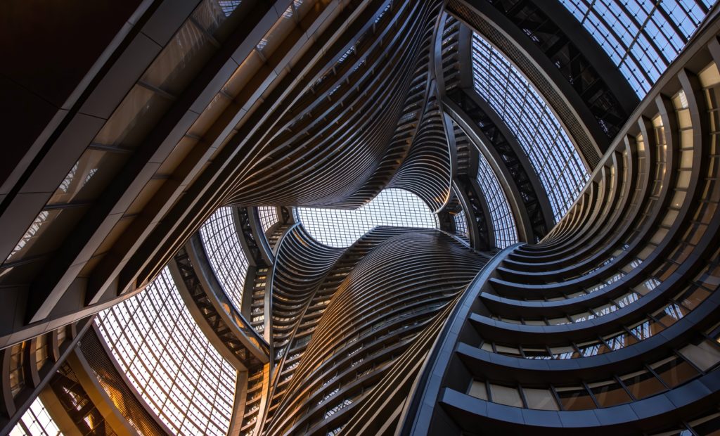 interior view of crazy Zaha Hadid building with curved forms and lots of glass