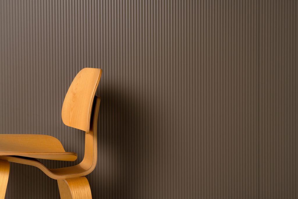 Profiles fluted designs in brown on wall with chair