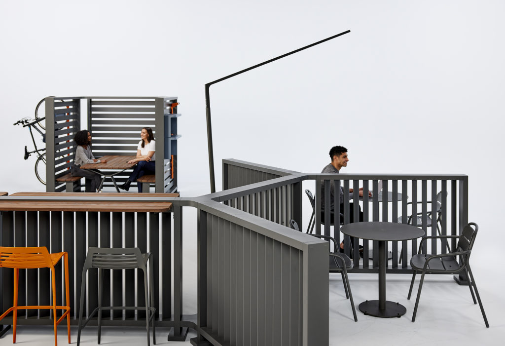 Backdrop with various tables, chairs, and worksurfaces