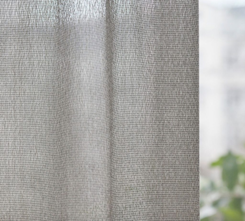window fabric detail of gray fabric with black threads