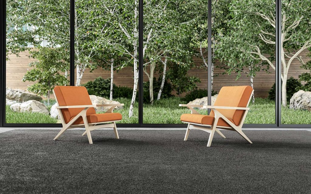 Gin chair two orange chairs in front of window with trees outside