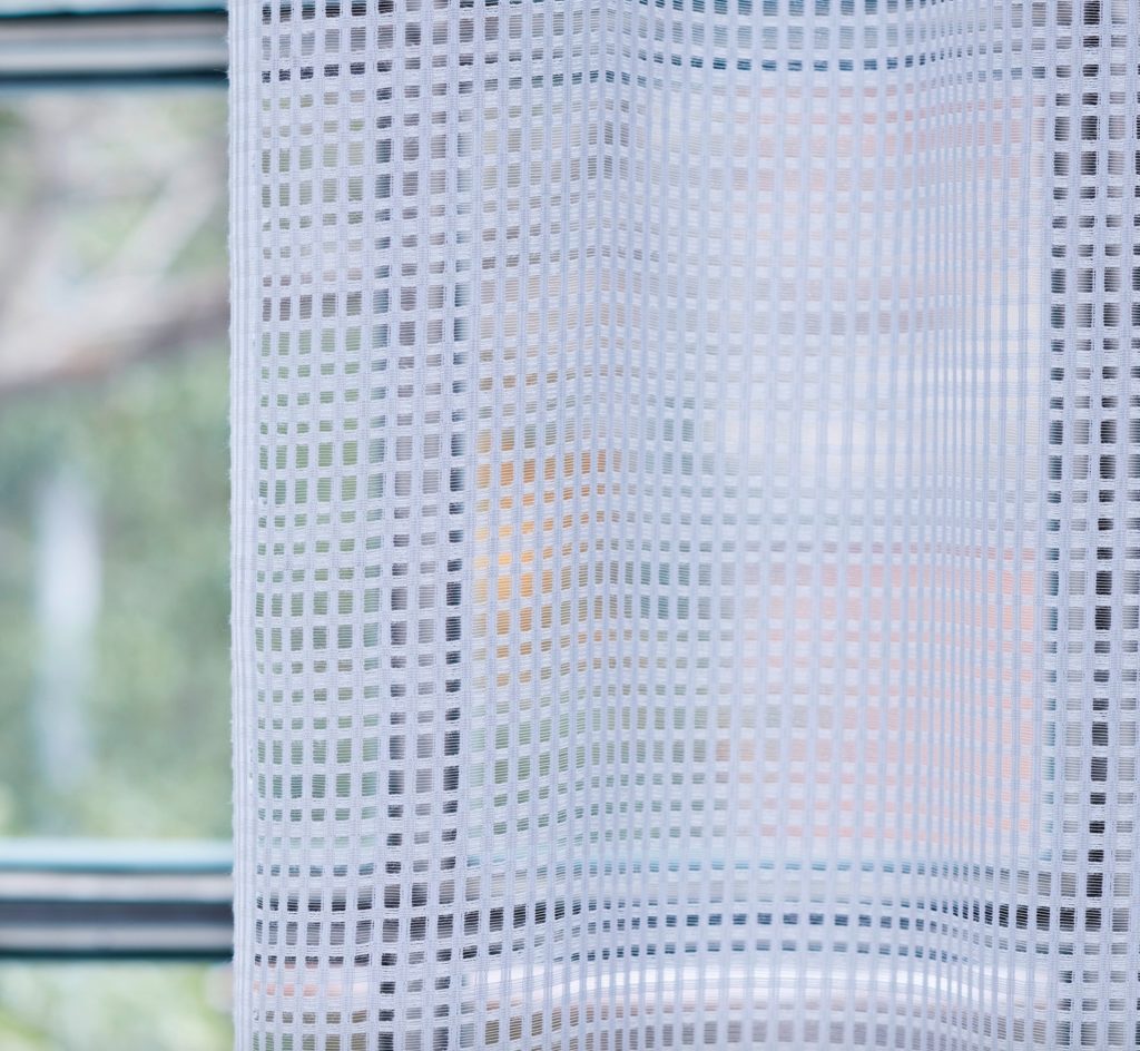 Detail of Manhattan fabric with grid pattern white textile