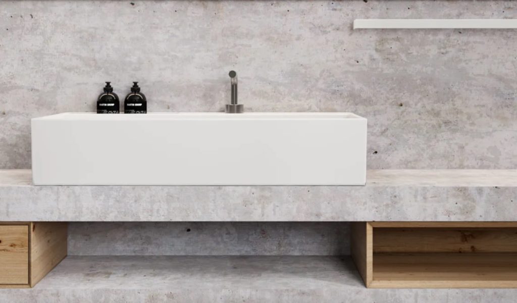NEXT white washbasin on countertop in marble covered bathroom