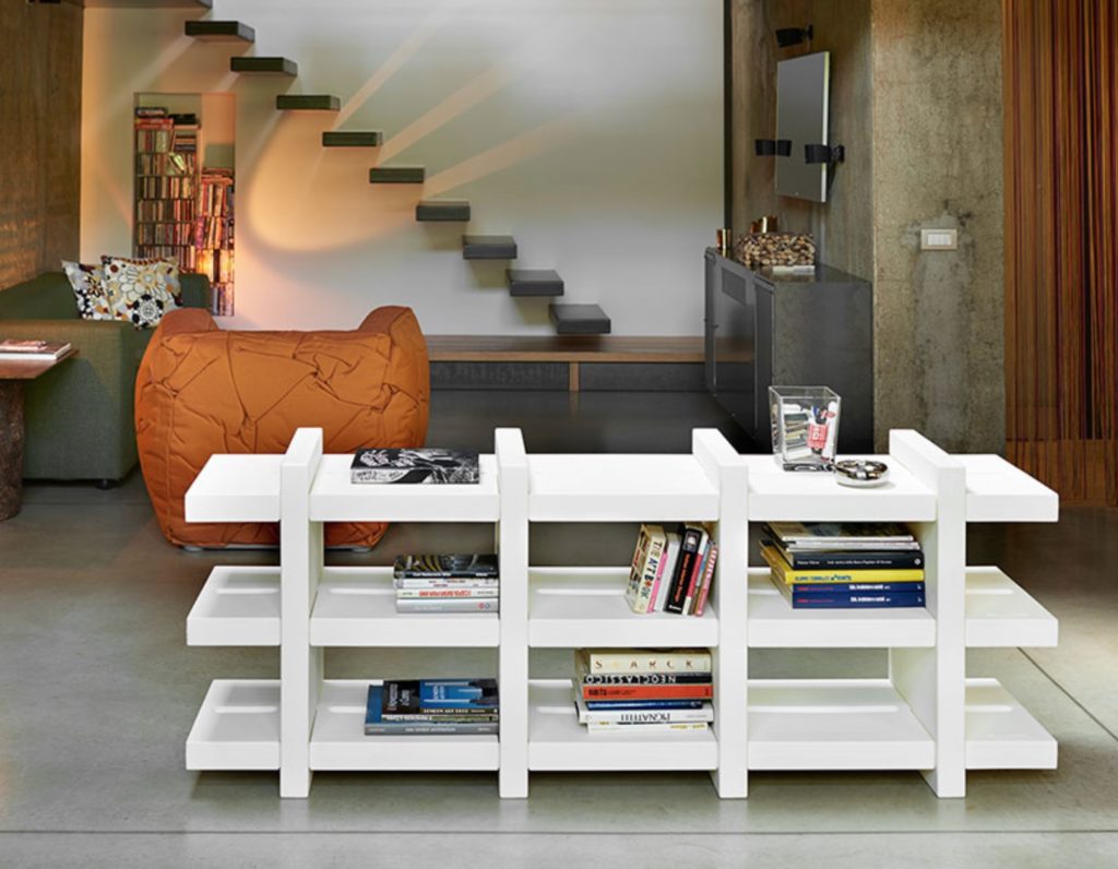 Booky in white in nice living room with floating stairs in background
