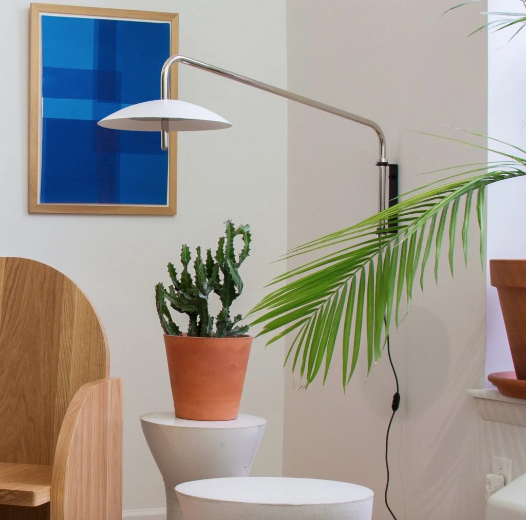 Signal Arm sconce with white shade in living room 
