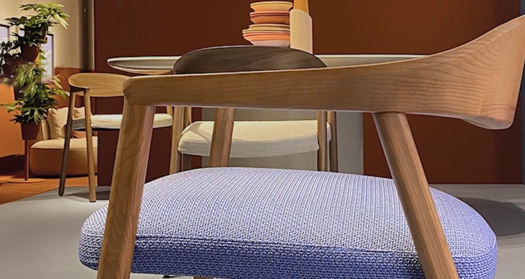 detail of arm and backrest with lilac upholstery visible