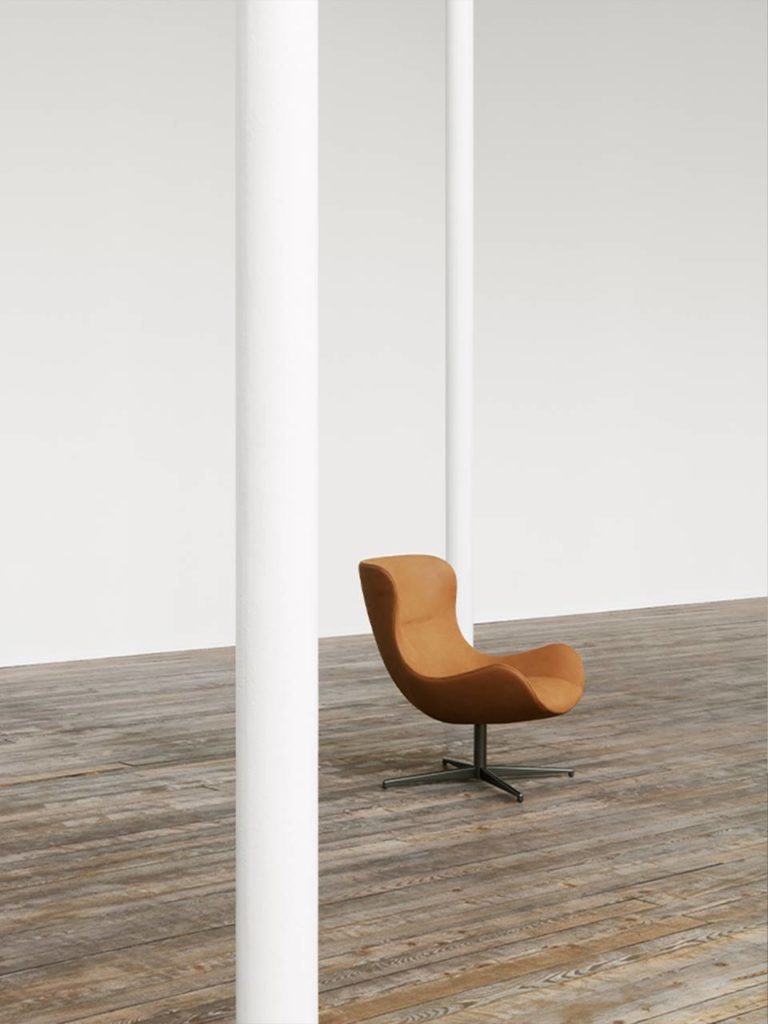 Oolong chair in rust leather on wood floor in white room