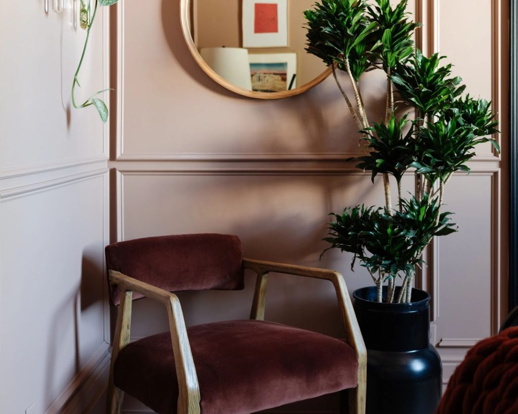 Super Paint Sherwin Williams Redend paint on wall with velvet upholstered chair in front