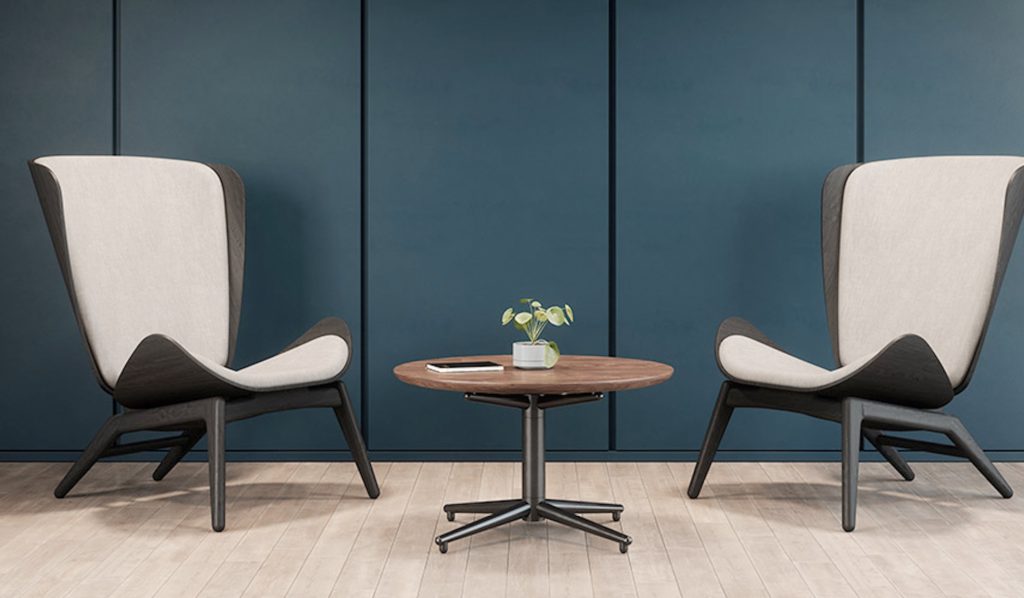 Vaux low table wood top, black base with two lounge chairs against blue wall