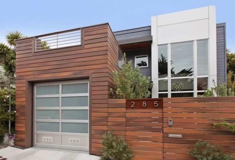 Wildwood cladding medium-toned wood color on home garage and fence