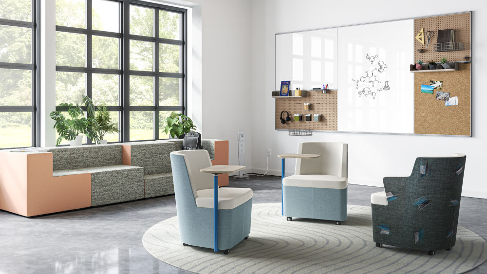 Three lounge chairs. Two with light blue/white upholstery and tablets and one with black/white upholstery with arms