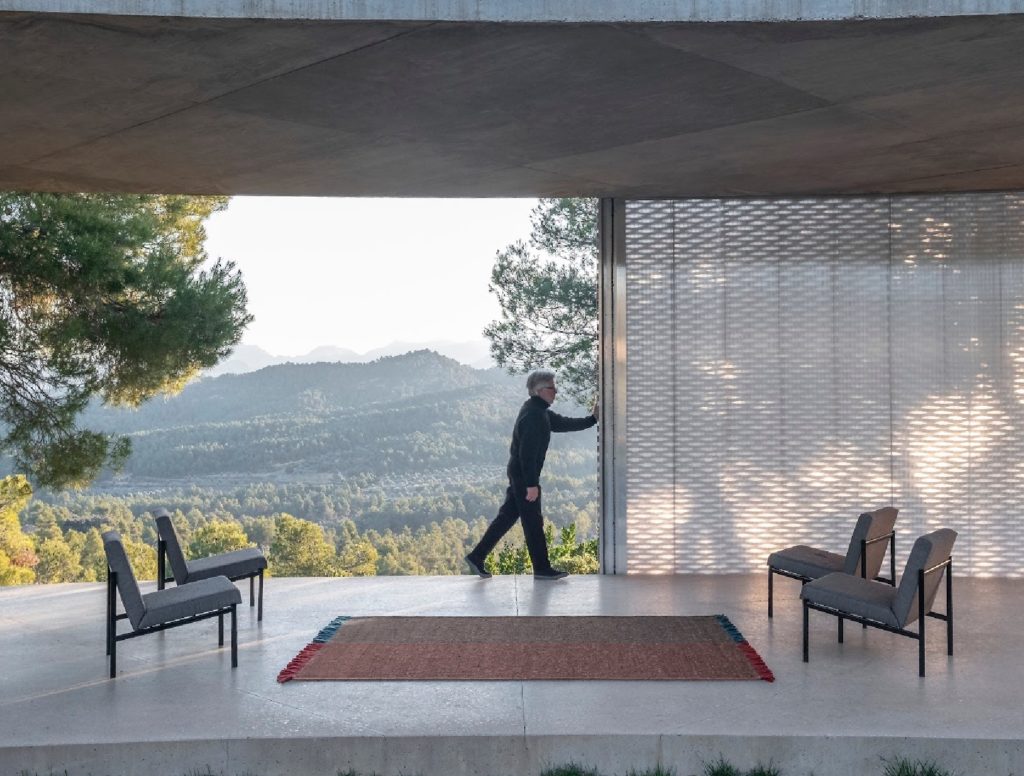 nanimarquina Re-rug outdoors on patio with man and mountains in the distance