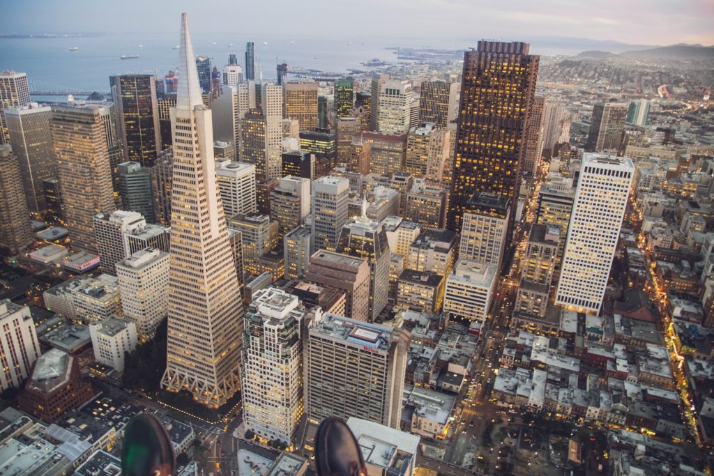 San Francisco skyline from above with office building and ocean in the distance.