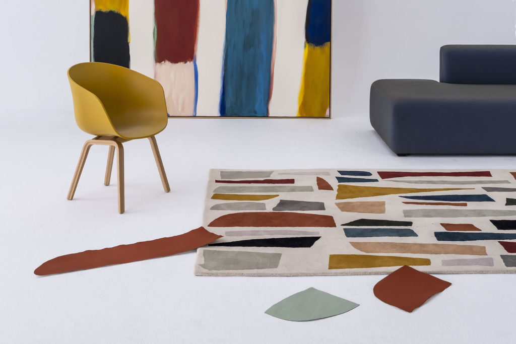 Tones rug on floor many different colors in asynchronous shapes