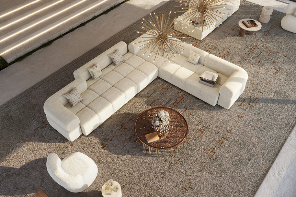 Qube sofa in white seen from above on large gray rug with starburst chandeliers