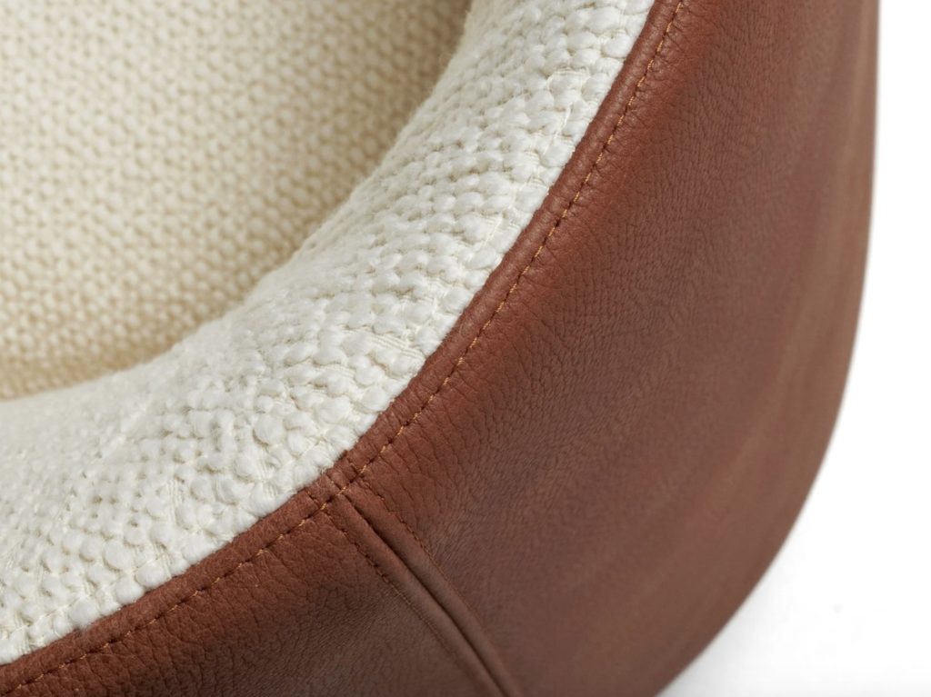 chair detail of leather upholstery and white textile upholstery