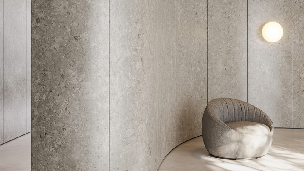 DI-NOC terrazzo finish on curved wall with single poufy chair