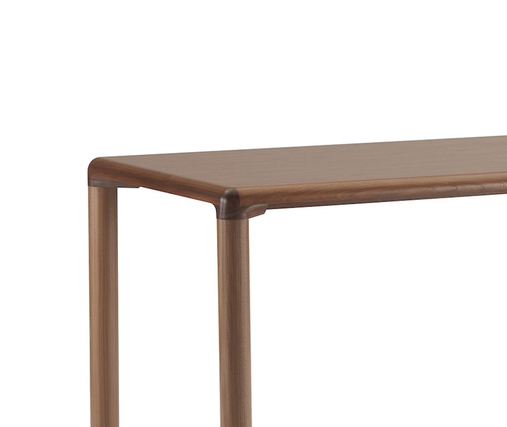 Conduit table in walnut, close-in view of leg meeting top