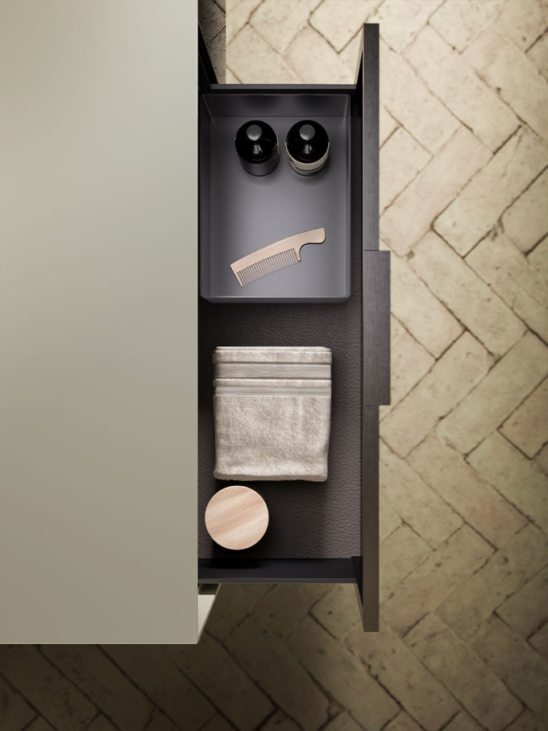 Overhead view of open drawer with comb and towel