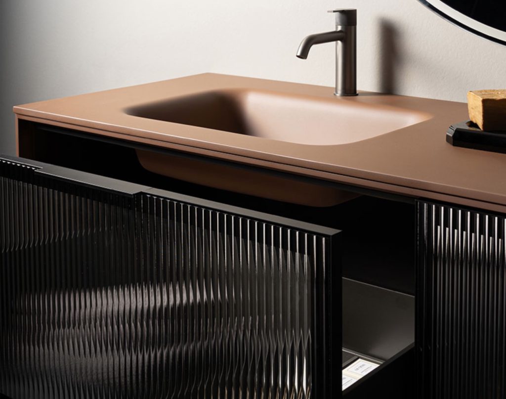 Heritage vanity with dark/translucent drawer fronts featuring vertical grooves