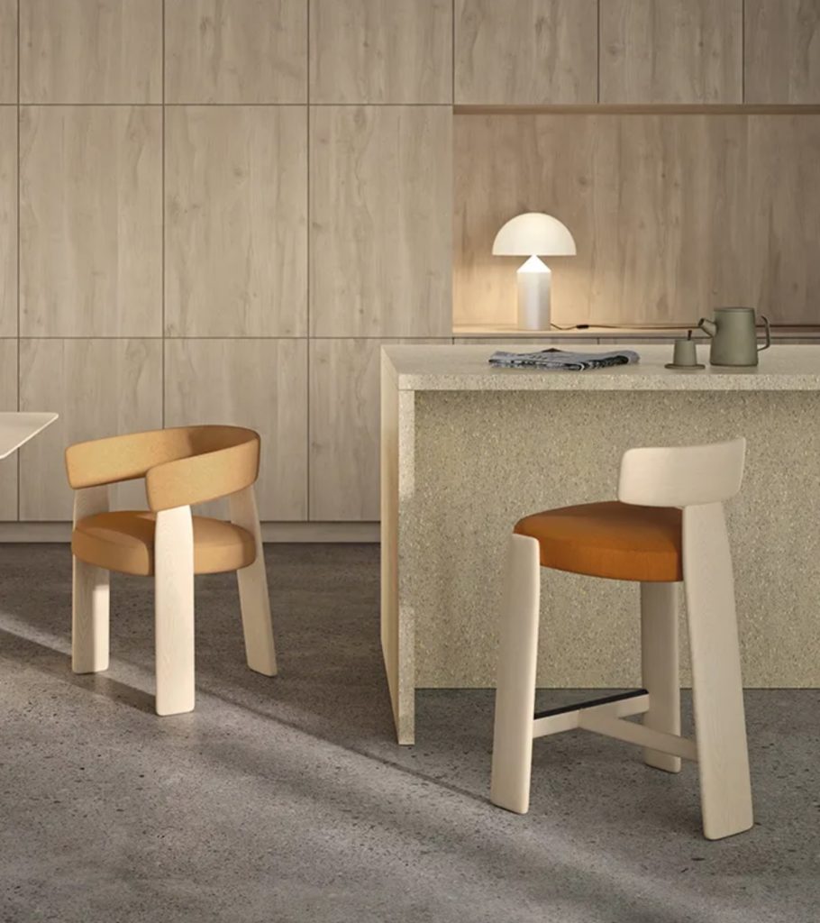 Oru chair two chairs one armchair and one stool in room with wooden cabinets and kitchen island