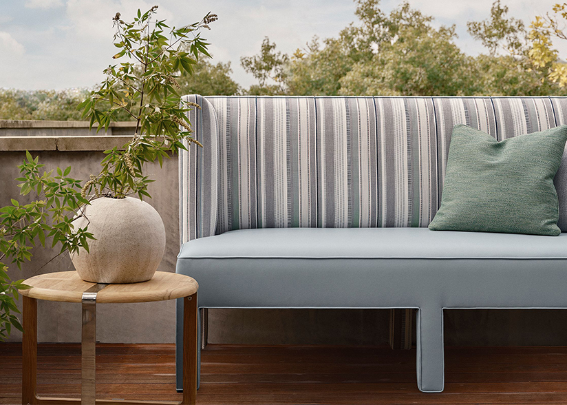 Hi 'N Dri on outdoor couch in a very light blue