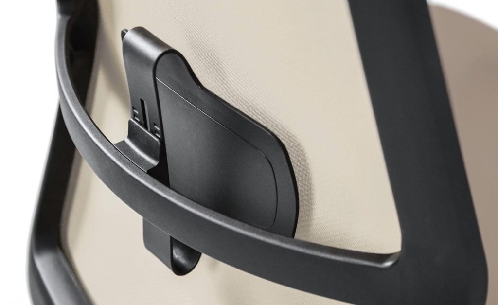 Detail of back of ergonomic office chair with light tan upholstery