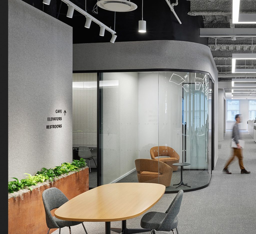 Curved glass wall detail in hallway of workspace