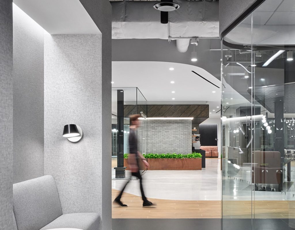 Fino curved glass with sitting area opposite and open foyer beyond