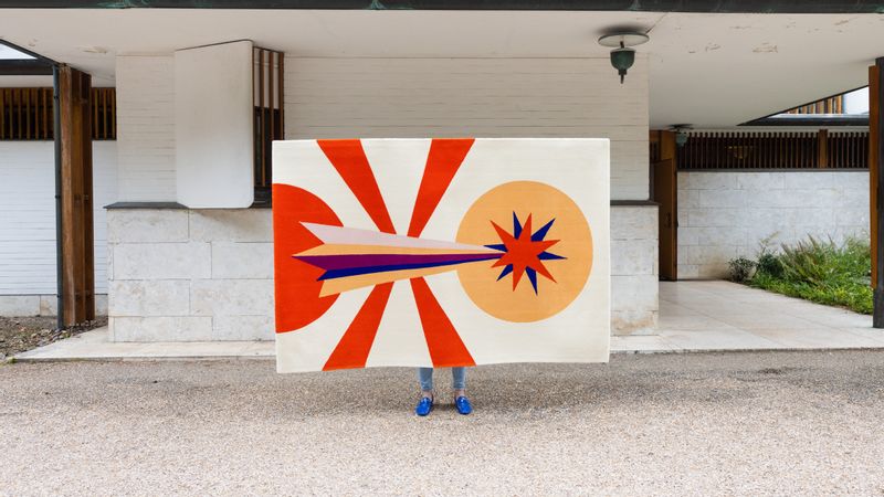 Kaboom rug abstract rocket and sun in red and peach tones