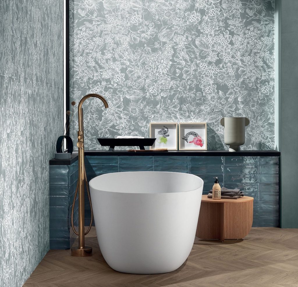 stoneware tiles above tub with same floral pattern of white/minty green