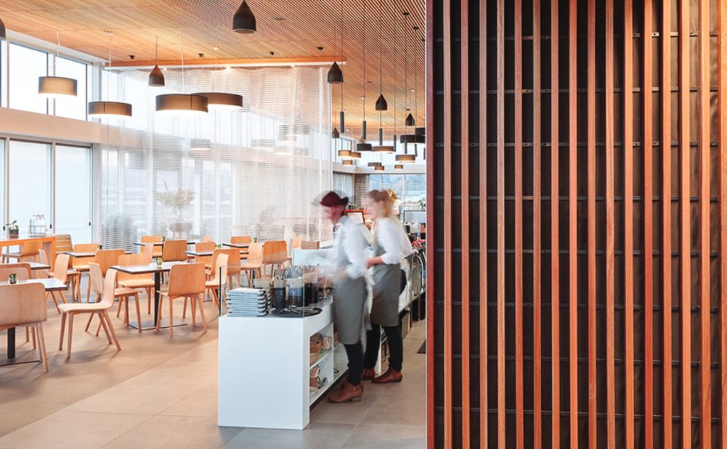 Unika Vaev wood panels on wall in sunny restaurant