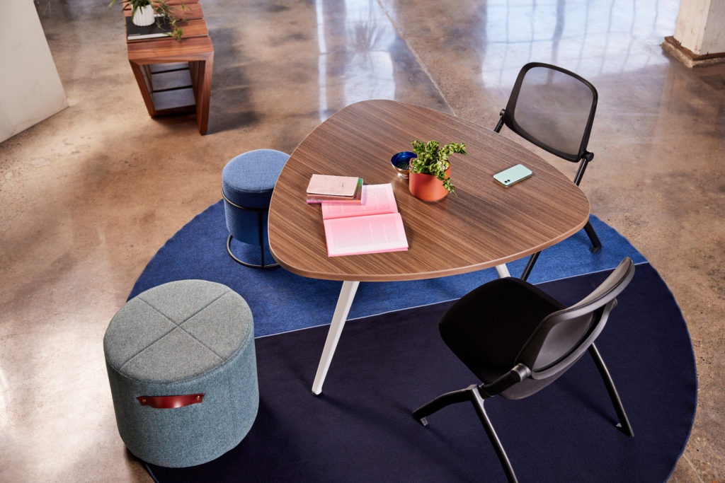 Birds-eye view of several chairs and ottomans around a small table